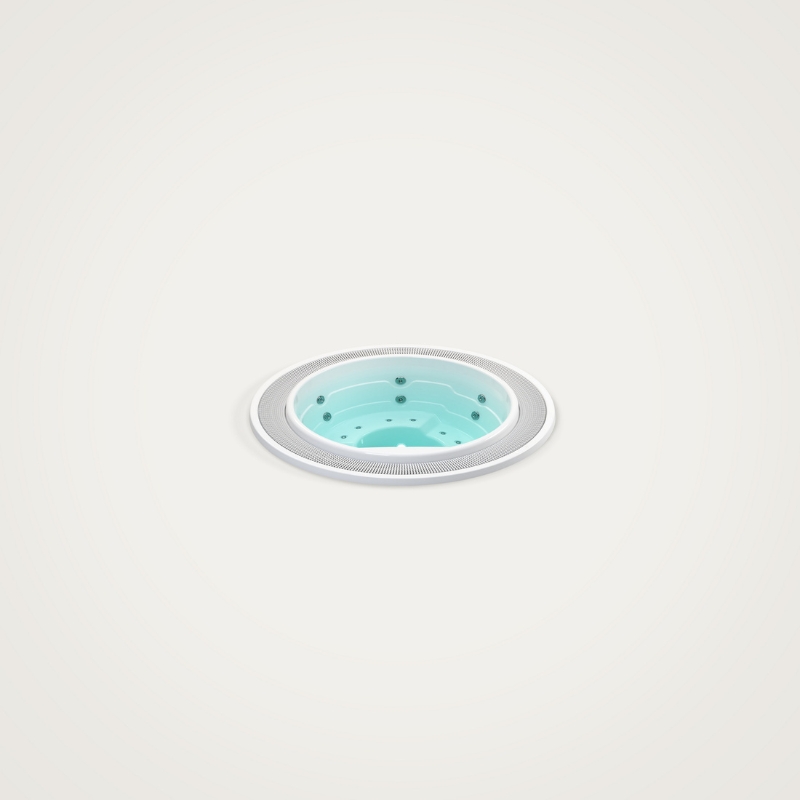 Okrągła wanna z hydromasażem z jasnoniebieską wodą i dyszami.