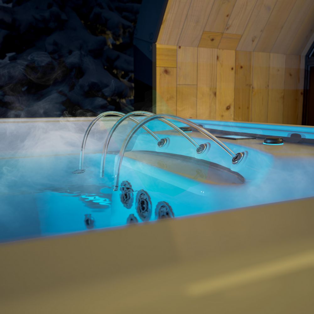 Parująca wanna spa z podświetlaną wodą i wylewkami przy drewnianym domku zimą.