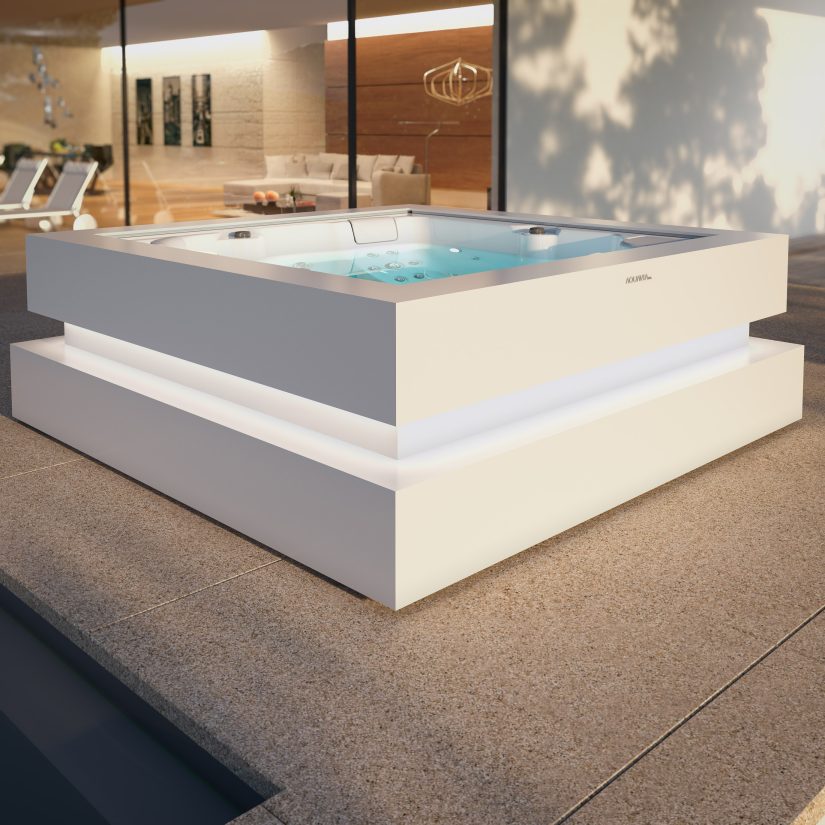 Nowoczesne jacuzzi ogrodowe Aquavia Spa z podświetleniem LED na tarasie przed domem.