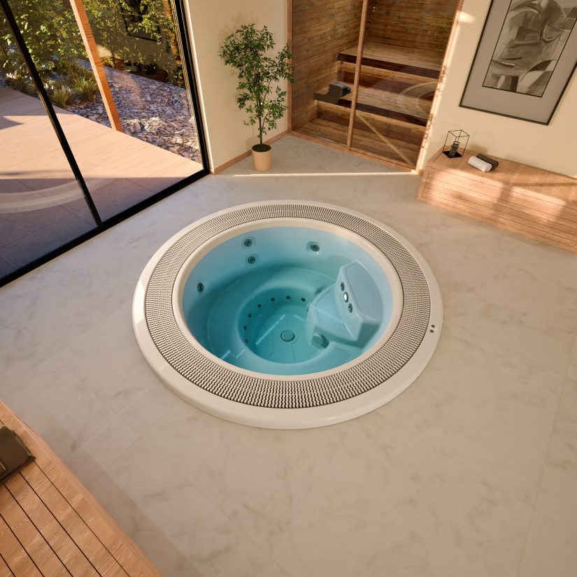 Okrągłe jacuzzi z błękitną wodą w nowoczesnej łazience z sauną i przeszklonym wyjściem na taras.