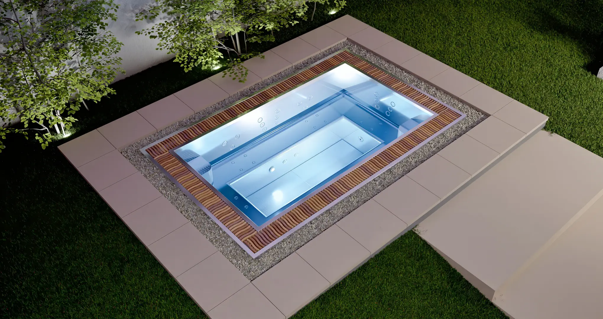 Podświetlany basen ogrodowy z hydromasażem otoczony drewnianym tarasem i trawnikiem.