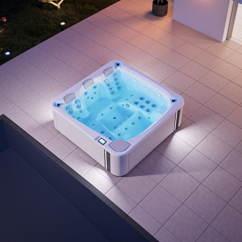 Podświetlane jacuzzi na tarasie przy basenie w nocy.